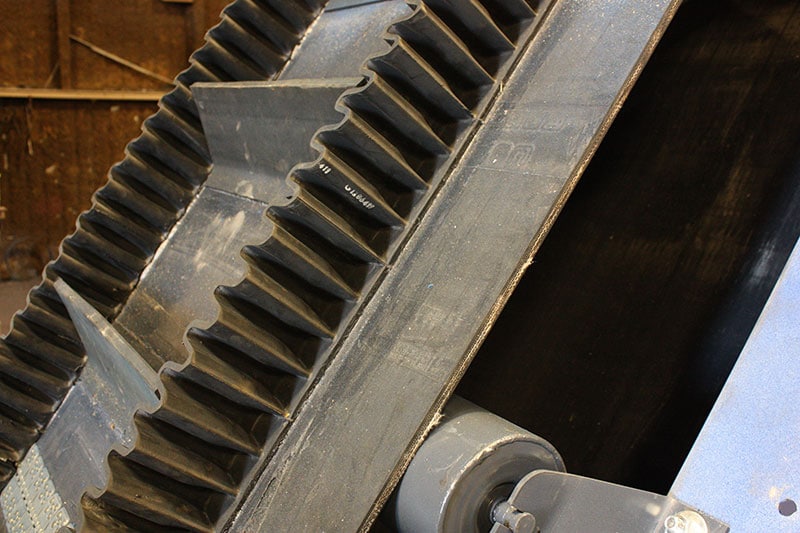 Close up cleated sidewall conveyor - Kase Conveyors